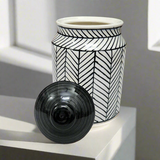 Black and white ceramic jar with geometric herringbone pattern and black lid, ideal for kitchen storage or home décor